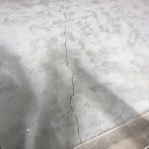 Cracked garage floor before epoxy restoration