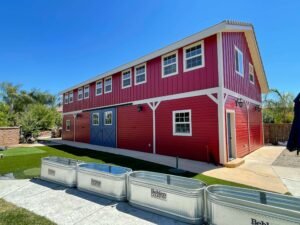 Completely restored barn exterior painted red with white trim and blue doors, a remarkable transformation