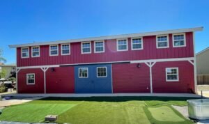 Barn with carpentry work and exterior painted in red with blue trim