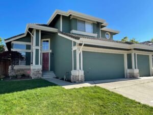 House exterior painted in green with white trim