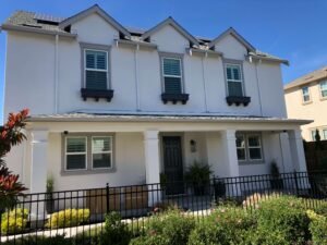 Large house painted white with brown trim