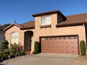 House exterior painted in light terracotta color with brown trim