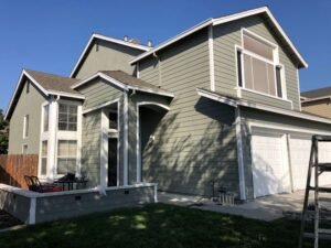 House exterior painted in olive green with white trim